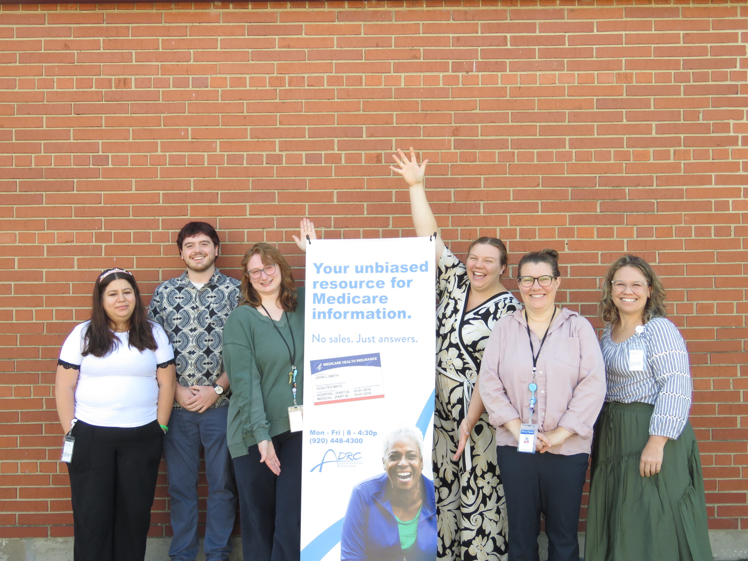 ADRC benefit specialists posing by a sign
