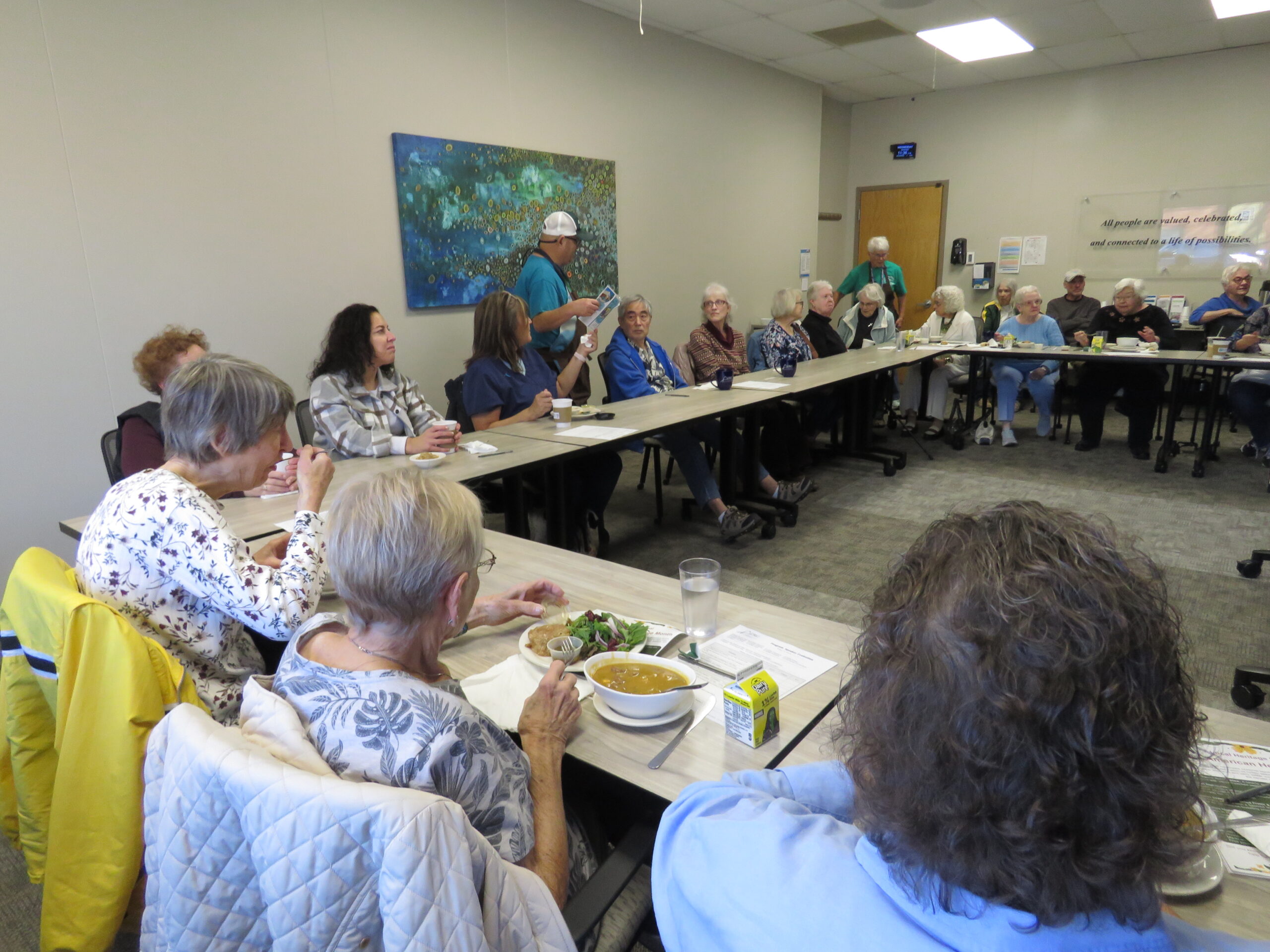 People eating during a presentation at the ADRC